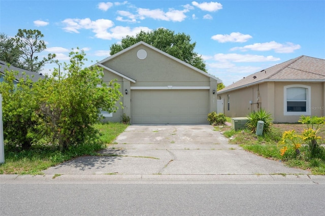8141 Golden Chickasaw Cir, Orlando, FL 32825 - view of front of house featuring concrete driveway, a garage, and stucco siding