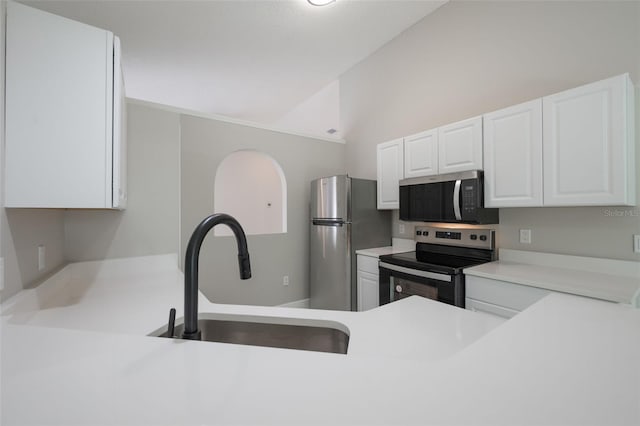 8141 Golden Chickasaw Cir, Orlando, FL 32825 - kitchen with appliances with stainless steel finishes, vaulted ceiling, light countertops, white cabinets, and a sink