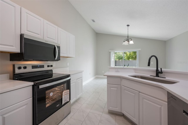 8141 Golden Chickasaw Cir, Orlando, FL 32825 - kitchen featuring stainless steel appliances, a sink, light marble finish flooring, light countertops, and lofted ceiling