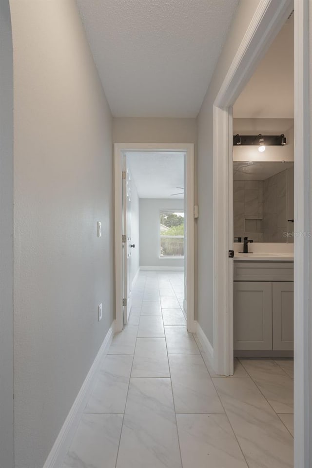 8141 Golden Chickasaw Cir, Orlando, FL 32825 - corridor with baseboards and a textured ceiling