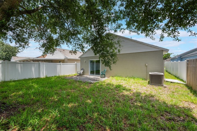 8141 Golden Chickasaw Cir, Orlando, FL 32825 - back of property with cooling unit, stucco siding, and a patio area