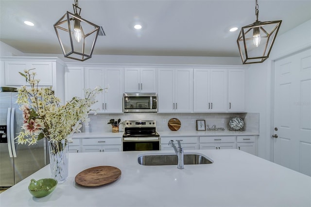 625 Dogfish Ln, Debary, FL 32713 - kitchen with appliances with stainless steel finishes, a sink, light countertops, backsplash, and white cabinets
