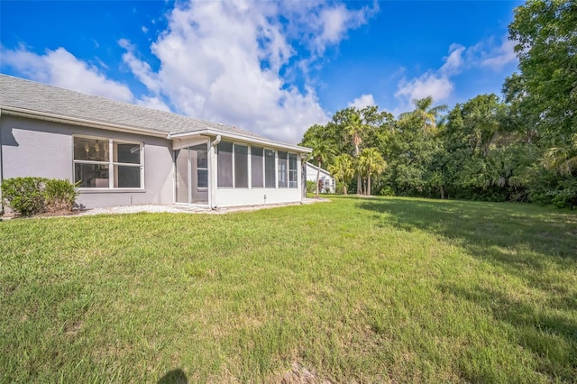 2015 Gardenia Landings Ln, Sun City Center, FL 33573 - back of house featuring a sunroom, a yard, and stucco siding