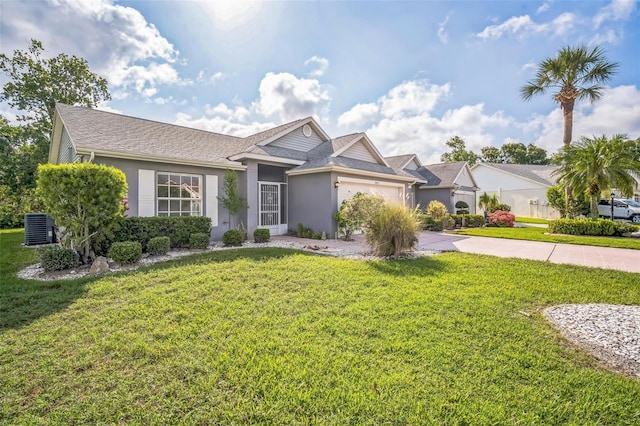 2015 Gardenia Landings Ln, Sun City Center, FL 33573 - ranch-style house with stucco siding, a garage, driveway, and a front lawn