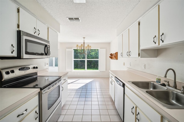 2015 Gardenia Landings Ln, Sun City Center, FL 33573 - kitchen featuring stainless steel appliances, a sink, light tile patterned floors, a chandelier, and light countertops