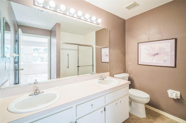 2015 Gardenia Landings Ln, Sun City Center, FL 33573 - bathroom featuring toilet, double vanity, a shower with door, tile patterned flooring, and baseboards
