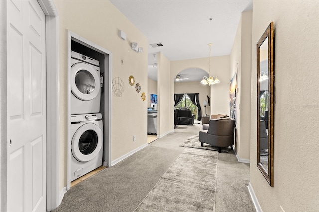 110 Watling Way Unit 25204, Davenport, FL 33837 - washroom featuring stacked washer / drying machine, carpet flooring, ceiling fan, baseboards, and a textured wall