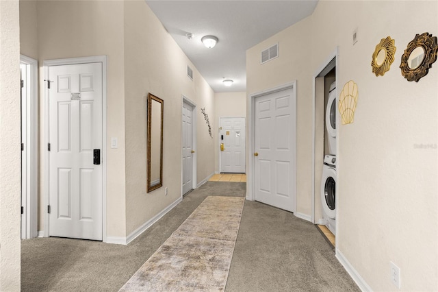 110 Watling Way Unit 25204, Davenport, FL 33837 - hall with stacked washer / dryer, carpet flooring, and baseboards