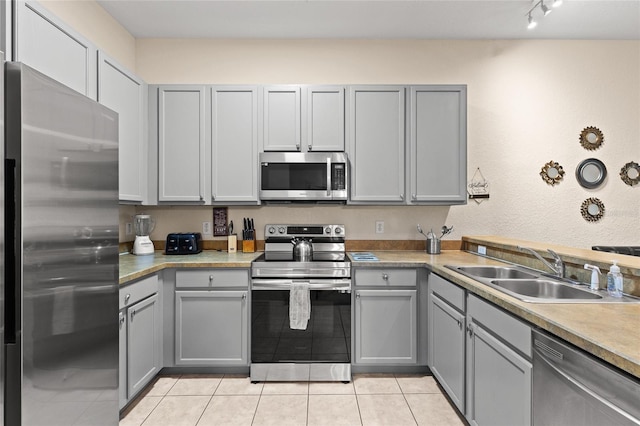110 Watling Way Unit 25204, Davenport, FL 33837 - kitchen featuring appliances with stainless steel finishes, gray cabinets, a sink, and light tile patterned floors