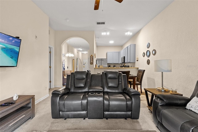 110 Watling Way Unit 25204, Davenport, FL 33837 - cinema room featuring light colored carpet, a ceiling fan, arched walkways, and baseboards