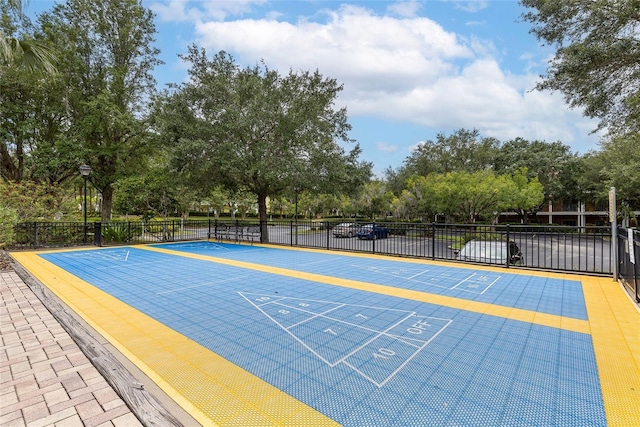 110 Watling Way Unit 25204, Davenport, FL 33837 - surrounding community with shuffleboard, uncovered parking, and view of scattered trees