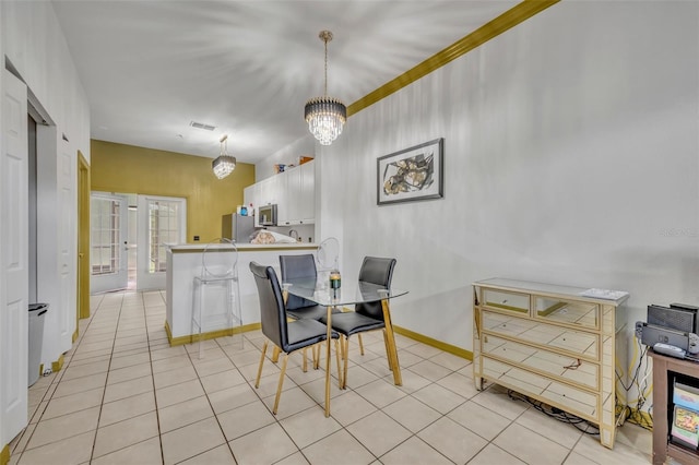 141 Reserve Cir Unit 113, Oviedo, FL 32765 - dining space featuring a chandelier, light tile patterned floors, and baseboards