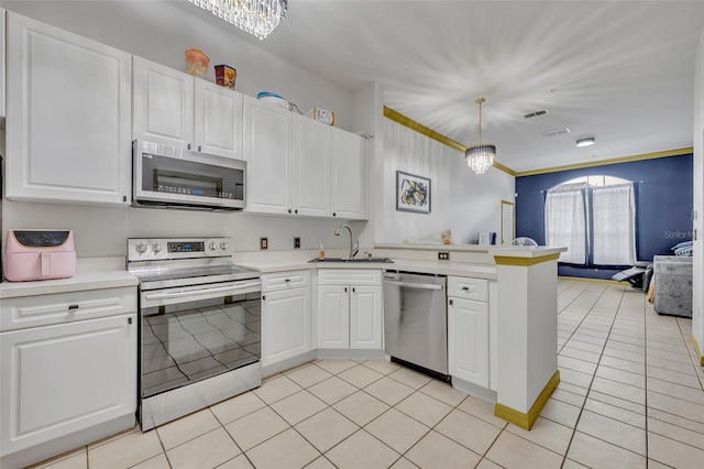 141 Reserve Cir Unit 113, Oviedo, FL 32765 - kitchen with stainless steel appliances, a sink, a peninsula, and light countertops
