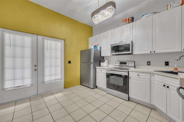 141 Reserve Cir Unit 113, Oviedo, FL 32765 - kitchen with stainless steel appliances, a sink, light countertops, and white cabinets