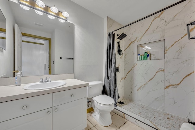 141 Reserve Cir Unit 113, Oviedo, FL 32765 - bathroom featuring toilet, vanity, a marble finish shower, and tile patterned flooring