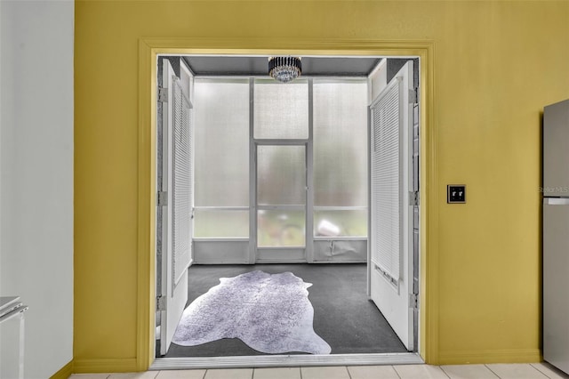 141 Reserve Cir Unit 113, Oviedo, FL 32765 - doorway to outside featuring baseboards, carpet, and tile patterned flooring