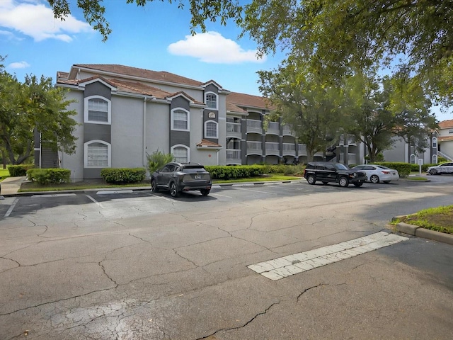 13917 Fairway Island Dr Unit 931, Orlando, FL 32837 - view of building exterior featuring uncovered parking and a residential view