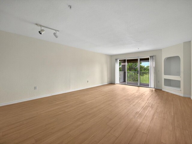 13917 Fairway Island Dr Unit 931, Orlando, FL 32837 - spare room with light wood finished floors, baseboards, and track lighting