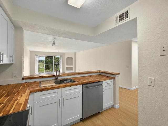 13917 Fairway Island Dr Unit 931, Orlando, FL 32837 - kitchen featuring wood counters, dishwasher, a sink, light wood-style floors, and a textured wall