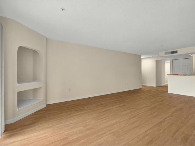 13917 Fairway Island Dr Unit 931, Orlando, FL 32837 - unfurnished living room with light wood-style flooring and baseboards
