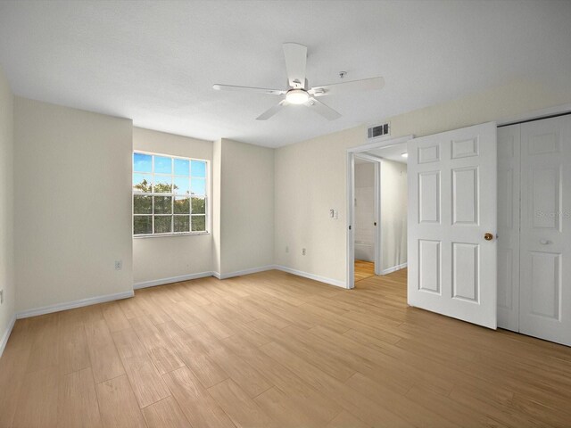 13917 Fairway Island Dr Unit 931, Orlando, FL 32837 - unfurnished bedroom featuring light wood-type flooring, baseboards, and a ceiling fan