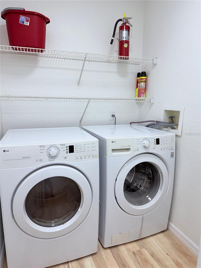 13917 Fairway Island Dr Unit 931, Orlando, FL 32837 - laundry area featuring separate washer and dryer, light wood-style floors, and baseboards