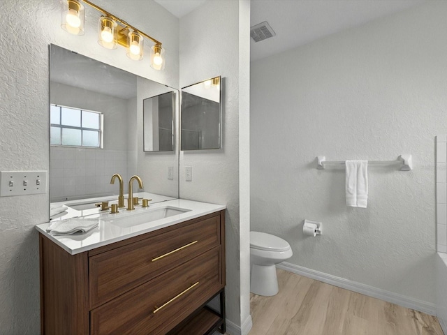 13917 Fairway Island Dr Unit 931, Orlando, FL 32837 - full bath with toilet, wood finished floors, vanity, a textured wall, and baseboards