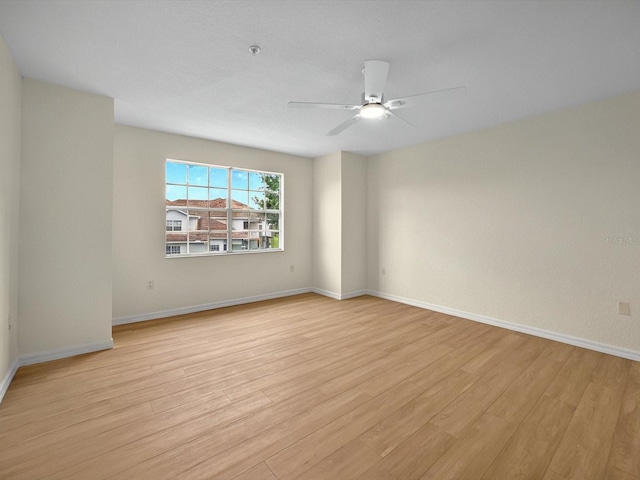 13917 Fairway Island Dr Unit 931, Orlando, FL 32837 - spare room featuring light wood-style flooring, ceiling fan, and baseboards
