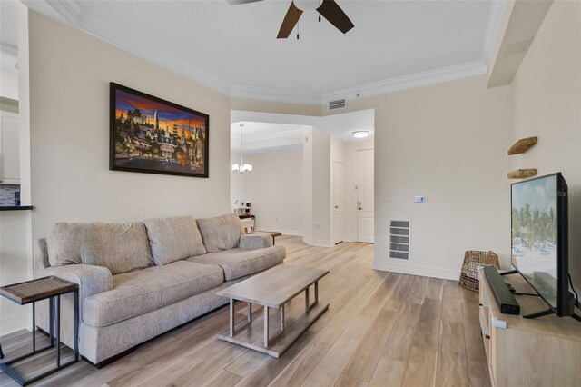 500 Mirasol Cir Unit 203, Celebration, FL 34747 - living area with a ceiling fan, light wood-style flooring, crown molding, baseboards, and a chandelier