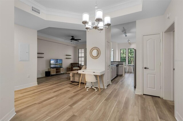 500 Mirasol Cir Unit 203, Celebration, FL 34747 - kitchen featuring a raised ceiling, a chandelier, light wood-type flooring, open floor plan, and crown molding