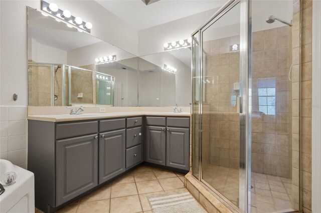 500 Mirasol Cir Unit 203, Celebration, FL 34747 - bathroom featuring a stall shower, double vanity, and tile patterned flooring