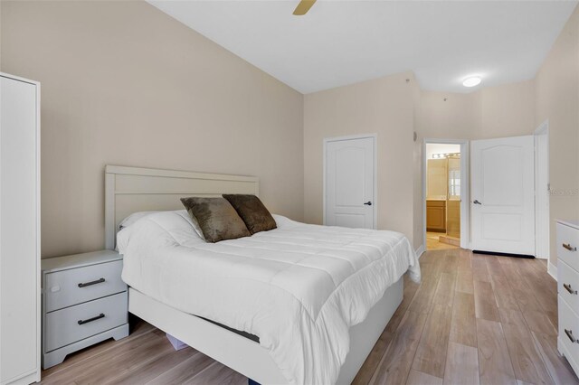 500 Mirasol Cir Unit 203, Celebration, FL 34747 - bedroom with light wood finished floors, ensuite bathroom, a ceiling fan, and baseboards
