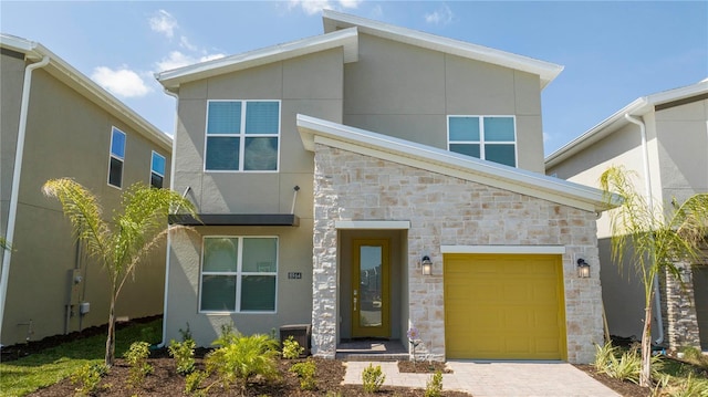 8964 Takeaway Way, Davenport, FL 33896 - contemporary house featuring stone siding, stucco siding, driveway, and a garage