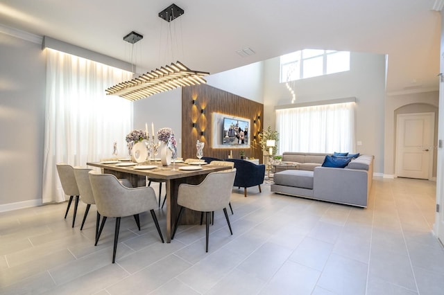 8964 Takeaway Way, Davenport, FL 33896 - dining area with crown molding, light tile patterned floors, and baseboards