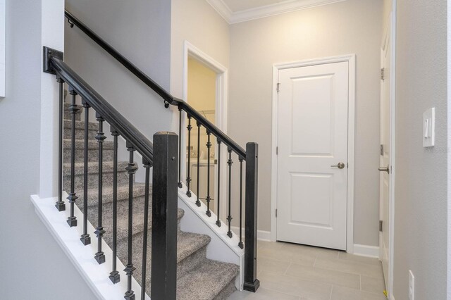 8964 Takeaway Way, Davenport, FL 33896 - stairway with crown molding, tile patterned floors, and baseboards