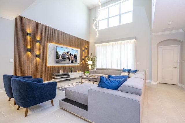 8964 Takeaway Way, Davenport, FL 33896 - tiled living area with a towering ceiling, baseboards, arched walkways, and ornamental molding