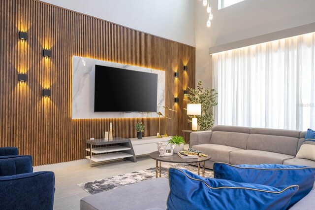 8964 Takeaway Way, Davenport, FL 33896 - living room featuring wooden walls and a high ceiling