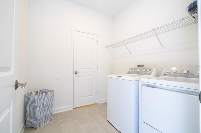 8964 Takeaway Way, Davenport, FL 33896 - laundry room featuring washer and clothes dryer, light tile patterned flooring, and baseboards
