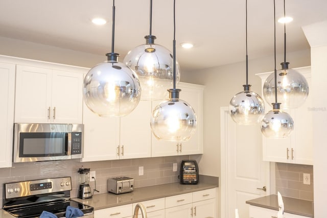 8964 Takeaway Way, Davenport, FL 33896 - kitchen featuring stainless steel appliances, decorative backsplash, white cabinetry, and recessed lighting