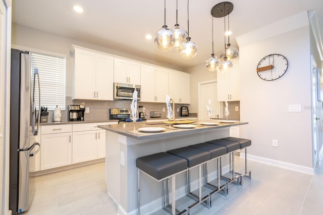 8964 Takeaway Way, Davenport, FL 33896 - kitchen featuring stainless steel appliances, backsplash, a breakfast bar area, white cabinets, and recessed lighting