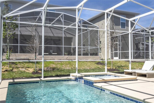8964 Takeaway Way, Davenport, FL 33896 - view of pool featuring glass enclosure, a patio area, and a pool with connected hot tub