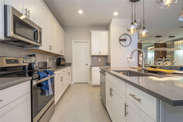 8964 Takeaway Way, Davenport, FL 33896 - kitchen featuring stainless steel appliances, dark countertops, a sink, tasteful backsplash, and recessed lighting