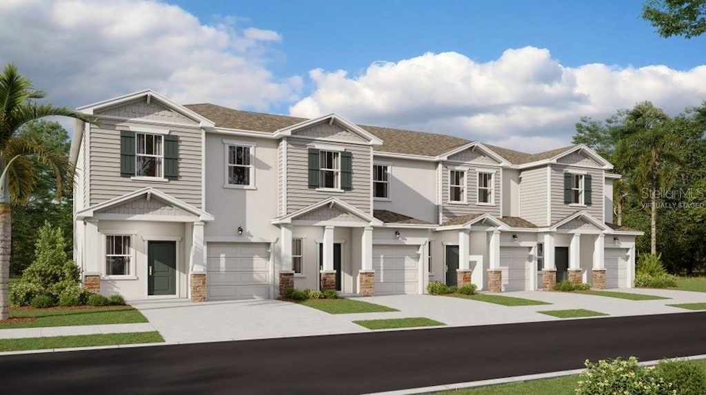 2679 Skyline Loop, Kissimmee, FL 34758 - view of property featuring driveway, an attached garage, and stone siding