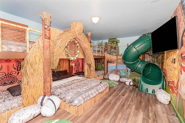 1403 Rolling Fairway Dr, Davenport, FL 33896 - bedroom featuring wood finished floors and a textured ceiling