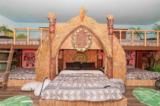 1403 Rolling Fairway Dr, Davenport, FL 33896 - bedroom with wood finished floors and a textured ceiling