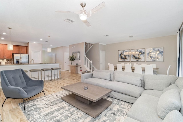 1403 Rolling Fairway Dr, Davenport, FL 33896 - living room featuring a ceiling fan, light wood-style flooring, stairway, and recessed lighting
