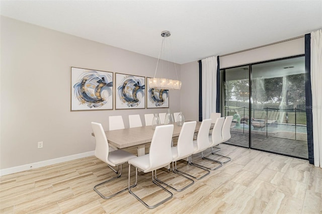 1403 Rolling Fairway Dr, Davenport, FL 33896 - dining space with baseboards, light wood finished floors, and a chandelier
