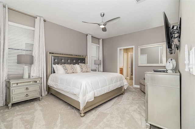 1403 Rolling Fairway Dr, Davenport, FL 33896 - bedroom featuring light carpet, connected bathroom, a ceiling fan, and baseboards