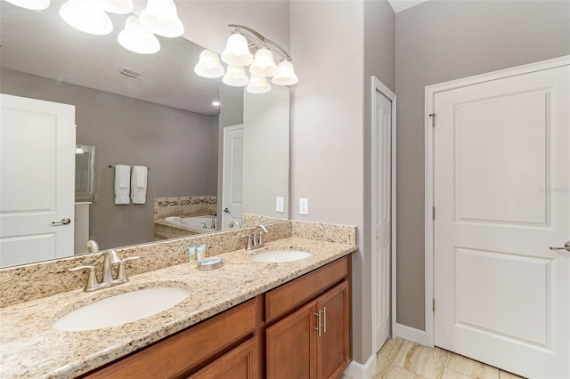 1403 Rolling Fairway Dr, Davenport, FL 33896 - bathroom with double vanity, a chandelier, a garden tub, and baseboards