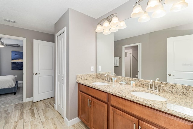 1403 Rolling Fairway Dr, Davenport, FL 33896 - ensuite bathroom with double vanity, a chandelier, baseboards, and a ceiling fan